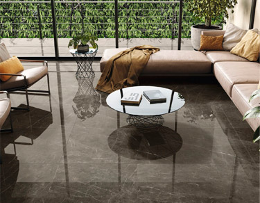 kinara-porcelanatos-españoles-cementado Ambiente interior sala con piso de porcelanato español cementado oscuro brilloso con betas claras
