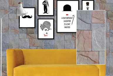 Kinara-las-mejores-piedras-decorativas-pared-distribución-y-venta-ecuador-HIMALAYA-GRAFITO pared revestida con piedra decorativa multicolor cuadros de Charles Chaplin y sofá mostaza