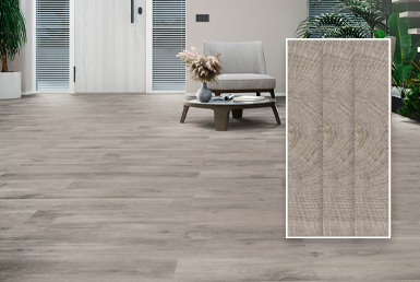 PORCELANATO -MADERADO-GRIS- BLUM GREY Porcelanato maderado gris en sala elegante con sillon de fondo gris claro y flores verdes